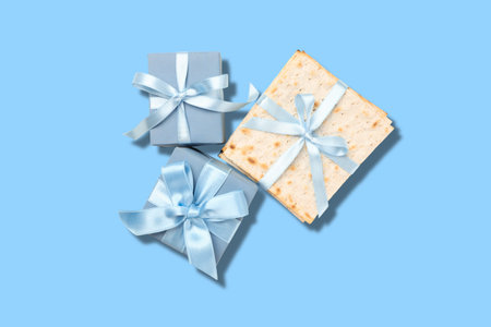 Matzah and wrapped gifts rest on a light blue surface