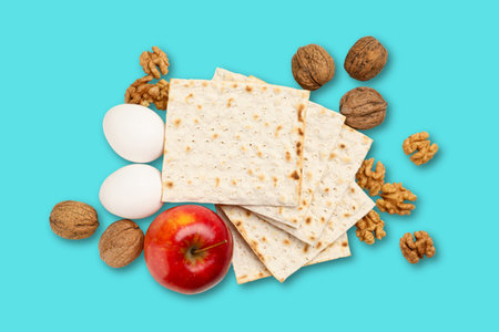 Matzah, eggs, nuts, and an apple are arranged together