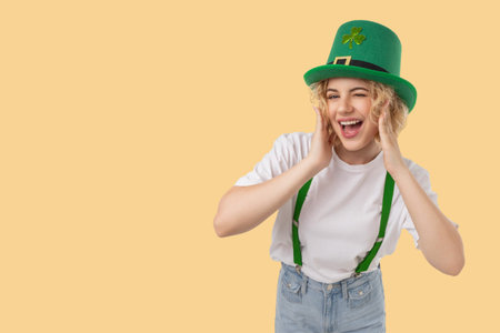 Woman smiles wearing a green hat and suspenders for St