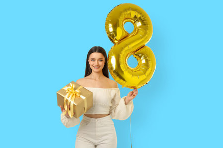 Young woman holds a gift and balloon for Women's Day