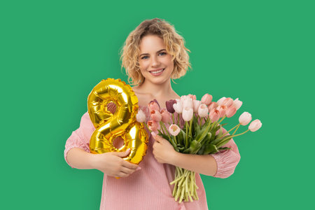 Woman holds flowers and a balloon to celebrate a holiday