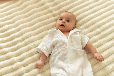 Curious baby enjoying playtime on soft textured surface