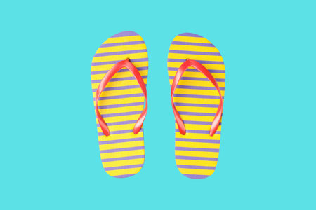 Flip flops with stripes in bright colors on a solid background