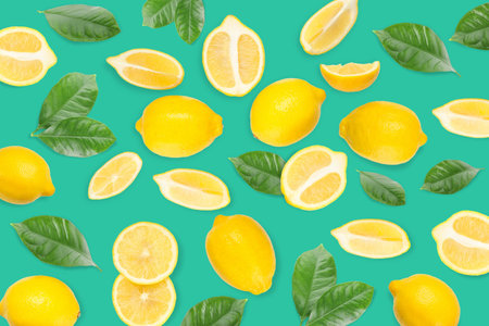 Lemons and slices with green leaves on a bright surface