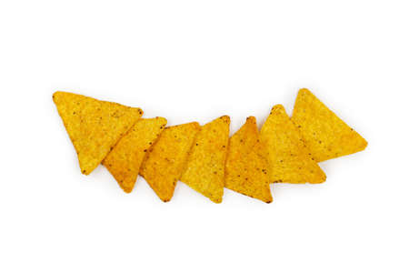 Corn triangles nachos chips laid out in a row one by one on a white backgroundの写真素材
