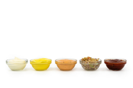 Bowls with Mexican cuisine sauces, guacamole, chili, raw, paprika on white background.の写真素材
