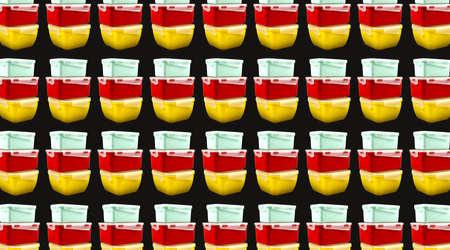 Yellow, mint and red plastic lunch boxes on a black background. Pattern