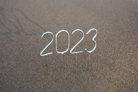 Figures for the upcoming New Year 2023 on the sand. New year celebration concept in exotic countryの写真素材