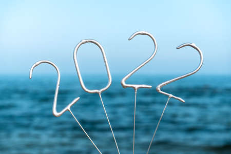 Figures for the upcoming New Year 2022 against the backdrop of the seaの写真素材
