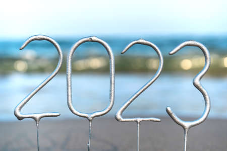 The numbers for the coming New Year 2023 amid waves on the beach. New year celebration concept in exotic country. Close upの写真素材