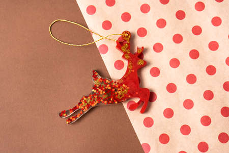 Red Christmas epoxy deer on the background of craft packaging for gifts. Christmas decorations on the tree.の写真素材
