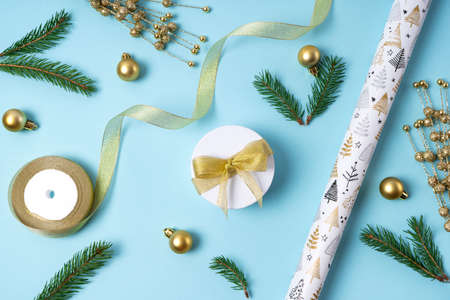 Christmas gold decorations on a light blue background. Holiday and celebration concept for postcard or invitation. view from above. flat layの写真素材