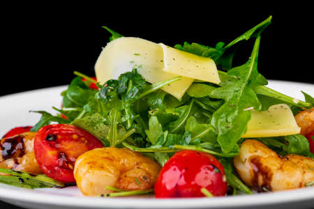 Salad with shrimp and cheese on black backgroundの写真素材