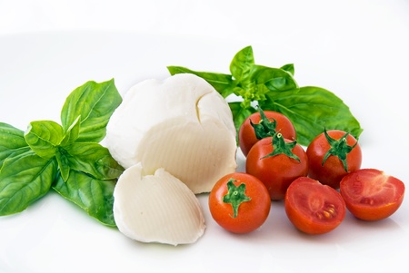 mozzarella, cherry tomatoes and basil om white backgroundの写真素材