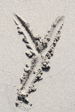The letter Y of the alphabet writing on the sand beachの写真素材