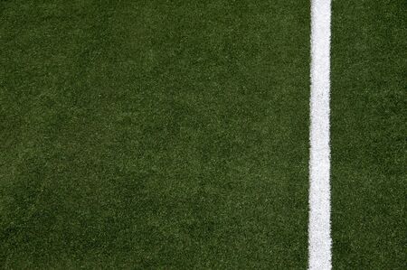 White stripes on the green soccer field from top view