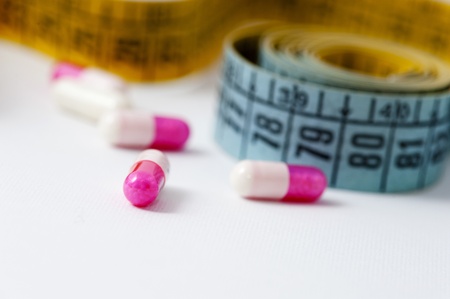 Measuring tape and pills for dieting conceptの写真素材