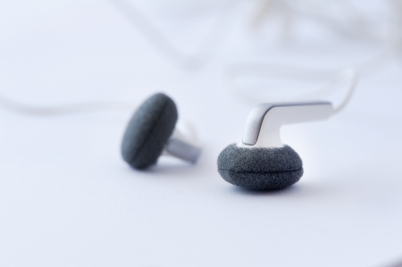 Modern portable audio earphones isolated on a white backgroundの写真素材