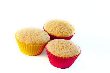Three tasty muffin cakes on a white table