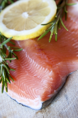 Fresh salmon with green rosemary and lemonの写真素材