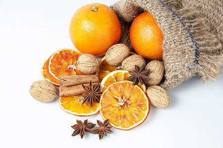 Christmas spices. Cinnamon sticks, anise stars, walnuts and sliced of dried orangeの写真素材