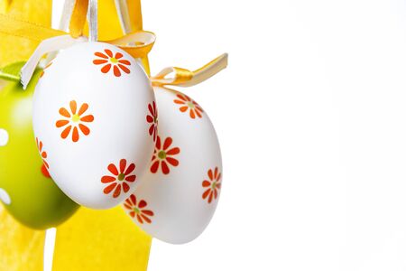 Easter eggs with a ribbon on a white の写真素材