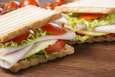 delicious sandwiches with chicken breast, salad, cheese and tomatoesの写真素材