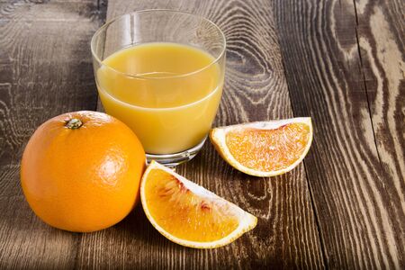 Orange juice on a wooden tableの写真素材