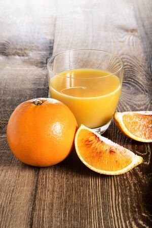 Orange juice on a wooden tableの写真素材
