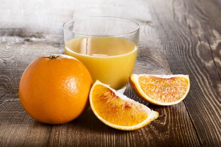 Orange juice on a wooden tableの写真素材