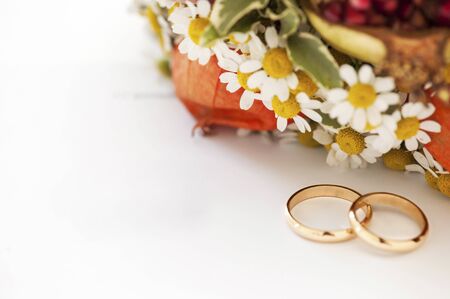 wedding rings and flowers on white backgroundの写真素材