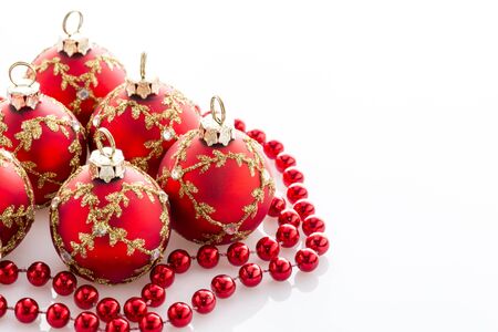 Red Christmas baubles and ribbon. Isolated on white backgroundの写真素材