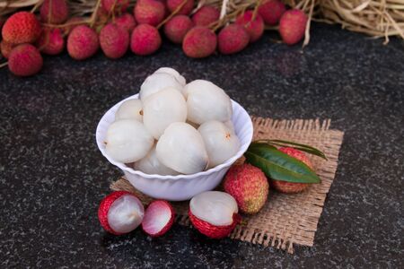 Litchi fruits. Fresh juicy lychee fruit on a ceramic plate. Organic leechee sweet fruit. Organic fruit concept. Exotic tropical litschi berry. Peeled lychee fruit.の写真素材