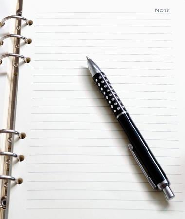 Opened blank notepad with pen in high resolution, the paper texture is clearly seenの写真素材