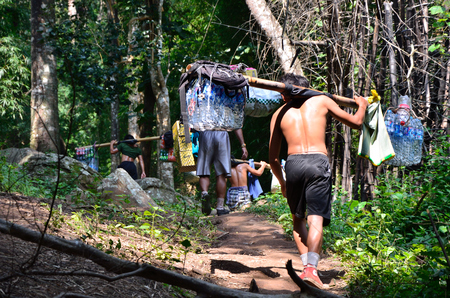 LOEI, THAILAND - OCT 11  Unidentified porters to carry climbers their belongings to the top of the mountain on 11 October 2013 at Phu Kradueng National Park, Loei, Thailandのeditorial素材