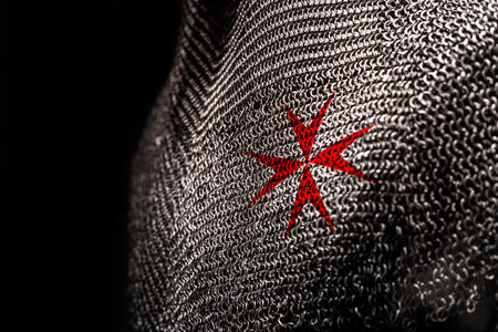 Medieval chainmail armour with a red cross on chest areaの写真素材