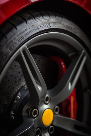 Detail of a front side wheel tire with red breaks and yellow centerの写真素材