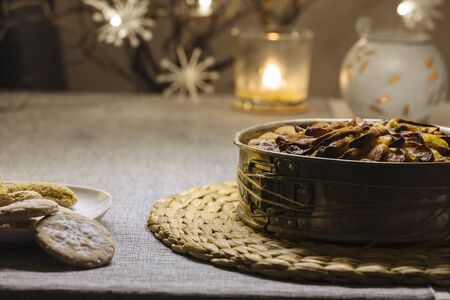 Christmas fruit cake on a table with white fur and apple fruit decorationの写真素材