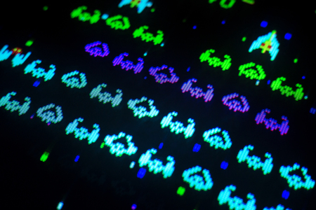 Detail of space ships with various colors of an old arcade video game