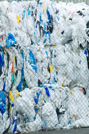 Packs and Stocks of Wrapped Scrap Plastic Dedicated for Eco Recycling in front of a Recycling Factoryの写真素材