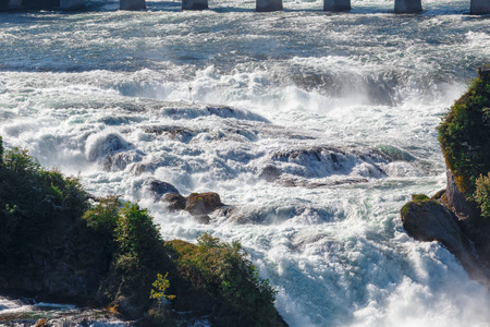 Rhine Falls is the largest waterafall in Europe and a big tourist attraction. The falls are situated on the High Rhine, on borders of cantons of Schaffhausen and Zürich next to Schaffhausen, in northern Switzerlandの写真素材