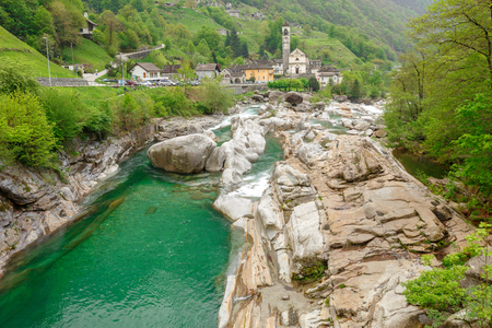View on the Lavertezzo village, famous tourist destination - An old Swiss village with double arch stone bridge at Ponte dei Salti with waterfall, Lavertezzo, Verzascatal, Canton Tessinの写真素材