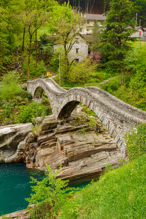 hiking Trail at the famous Roman Bridge called Ponte dei Salti in Lavertezzo,Verzasca Valley,Ticino Canton,Switzerlandの写真素材