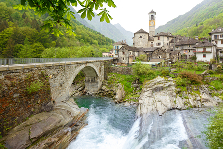 View on the Lavertezzo village, famous tourist destination - An old Swiss village with double arch stone bridge at Ponte dei Salti with waterfall, Lavertezzo, Verzascatal, Canton Tessinの写真素材