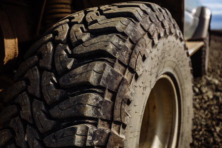Detail of a black offroad tire on a offroad truck vehicle, built for heavy rides and unpaved roads