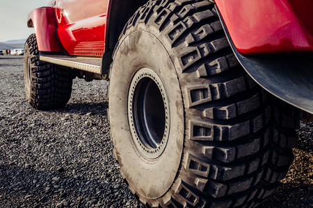 Detail of a black offroad tire on a offroad truck vehicle, built for heavy rides and unpaved roads