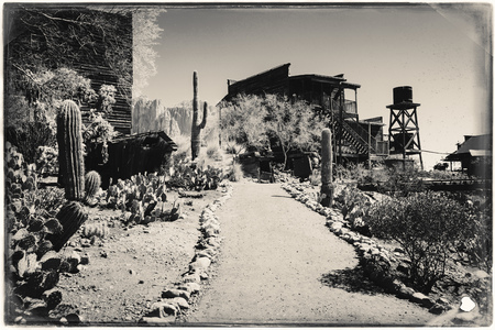 Black and White Sepia Vintage Photo of Old Western Wooden Buildings in Goldfield Gold Mine Ghost...