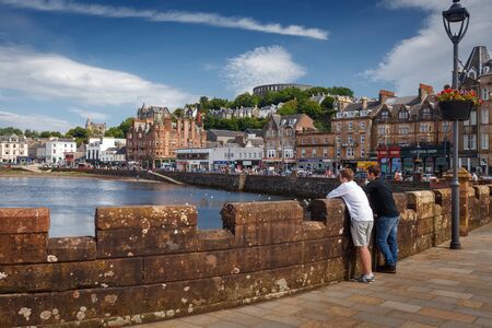 July 25, 2019 - Oban, Scotland, UK: Oban City Center with tourist at the waterfront and various...