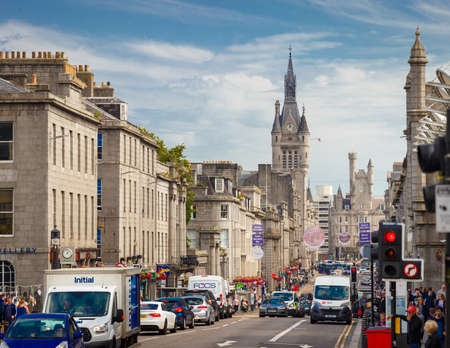 July 31, 2019: Aberdeen, Scotland, UK - Union Street with daily car traffic in Downtown Aberdeen City Centre with Aberdeen Town House, in Scotland, UKのeditorial素材