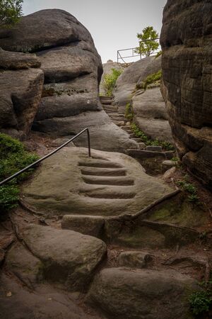 Series of stairs and steps carved in a sandstone, leading to Supi Hnizdo (vulture's nest) on a beautiful hiking trail in Czech Switzerland, Czechiaの写真素材